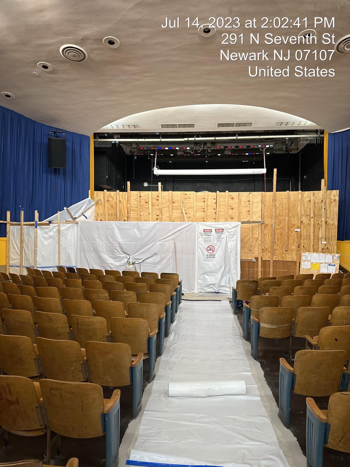 Asbestos containment and decontamination enclosure built inside a school auditorium in Newark, NJ